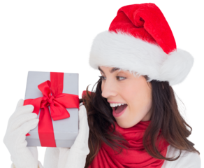 Astonished brunette in santa hat showing gift