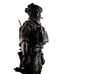 Low angle half length shot of a military army soldier in camouflage holding assault rifle. Studio...