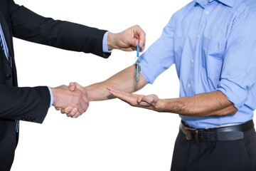 Businessman shaking hands and giving keys