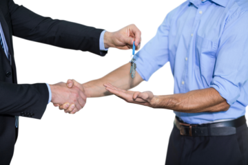 Businessman shaking hands and giving keys