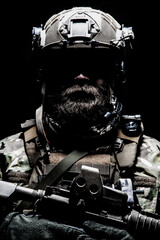 Close up, low key half length portrait of bearded commando fighter, army special forces soldier,...