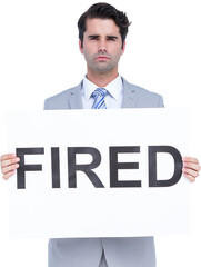 Portrait of upset businessman holding fired sign