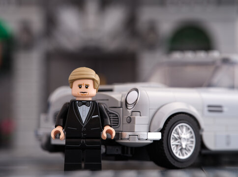 Tambov, Russian Federation - January 06, 2023 A Lego No Time to Die-James Bond minifigure standing near his 007 Aston Martin DB5 gray car by LEGO Speed Champions. Close-up