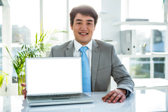 Businessman smiling while showing laptop