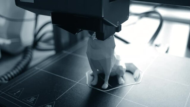 3D printer. 3d printer printing close-up. Molten plastic flowing out of extruder and forming prototype model. New modern additive technologies for printing 3D printer. Electronic device for modeling.