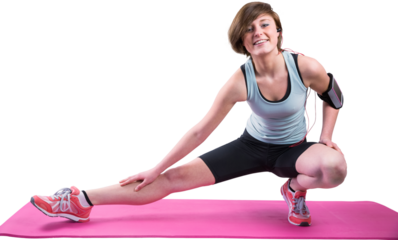 Pretty brunette looking at camera and stretching her leg on exercise mat