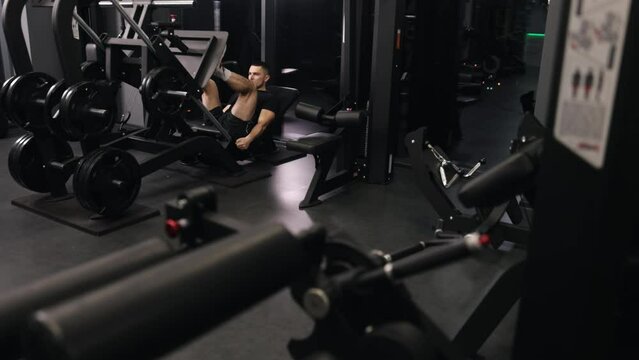 Leg exercise, Physical activity, Well-built coach. In pursuit healthy lifestyle, handsome trainer engages in sports and gym workouts.