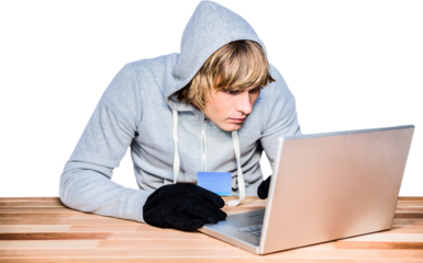 Man in hood jacket hacking a laptop