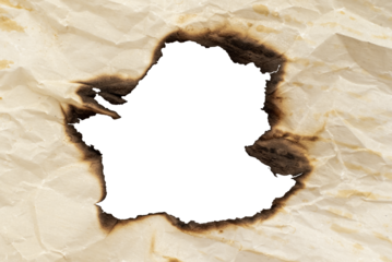 A hole in the scorched old yellow, crumpled paper. Baking paper after fire. Fire