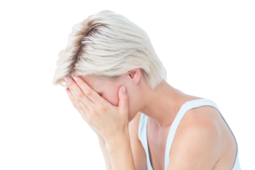 Sad blonde woman crying with head on hands
