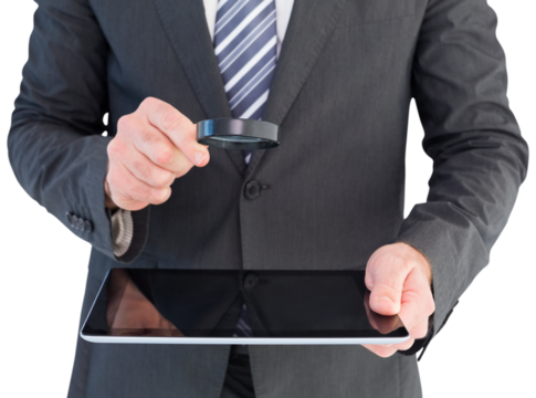Businessman looking at tablet with magnifying glass - Powered by Adobe