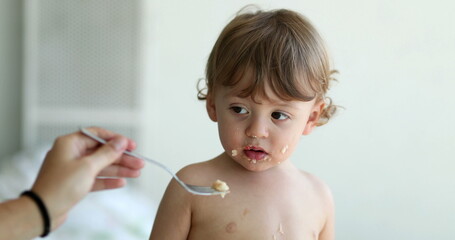Baby boy refusing food. Child infant not wanting spoon