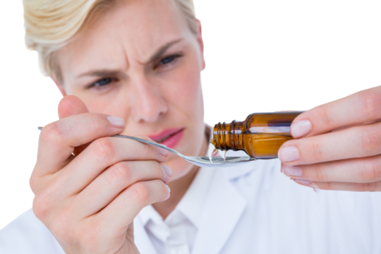 Doctor pouring medicine on spoon