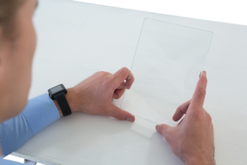 High angle view of businessman using glass interface at table