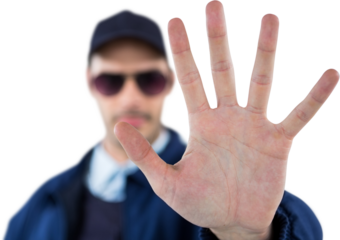 Confident security officer making stop gesture