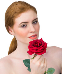 Obraz premium Beautiful redhead posing with red rose