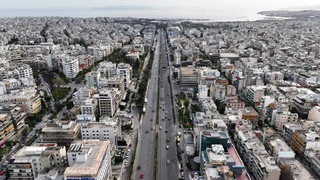 Aerial drone time-lapse video of famous avenue of Syggrou and urban cityscape leading to Athens riviera, Attica, Greece