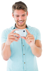 Handsome young man taking photo with smartphone