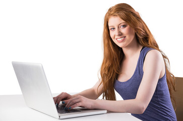 Naklejka premium Pretty redhead working on laptop
