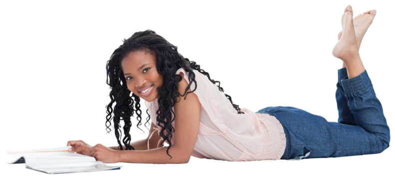 A woman lying on the floor smiling at the camera with a magazine in front of her