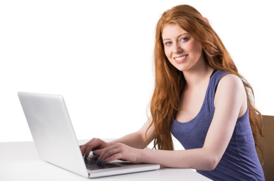 Pretty redhead working on laptop