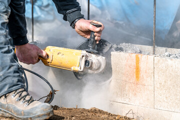 cutting concrete bricks with an electric grinder