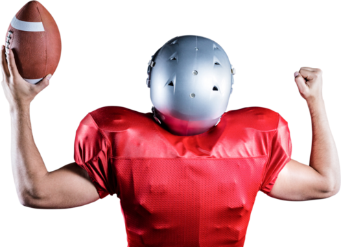 Rear view of American football player cheering while holding ball