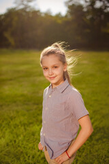teen girl walking in park after classes and meeting with friends after school
