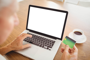 Elderly man spending money on internet