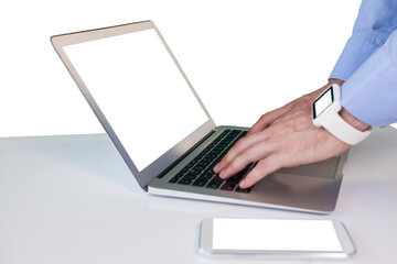 Fototapeta na wymiar Cropped hands of businessman using laptop