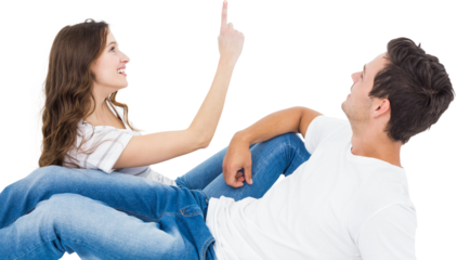 Happy couple lying on floor and pointing up