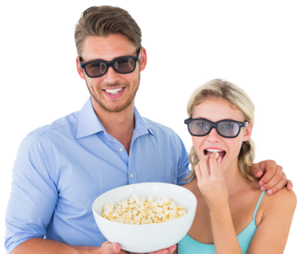 Happy young couple wearing 3d glasses eating popcorn