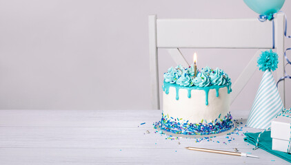 Blue Birthday cake, hats and balloons over white background. - 588462588