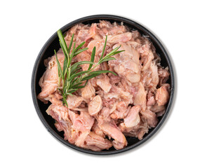 Canned pork or chicken stew in a black bowl with rosemary on a white isolated background. Stewed healthy food.