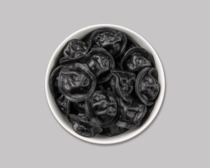 Black dumplings with meat on a gray isolated background. Russian seberian tradition food.