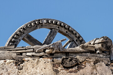 Traditional old Greek windmill, ruined in sunny sky