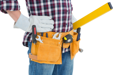 Repairman wearing tool belt while standing with hands on hips