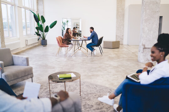 Diverse colleagues working in spacious workspace