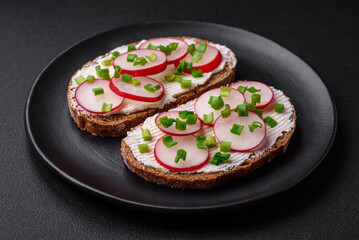 Delicious sandwich or bruschetta with cream cheese radish and green onions