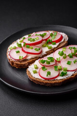 Delicious sandwich or bruschetta with cream cheese radish and green onions
