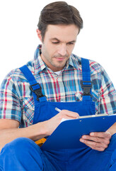 Plumber writing notes on clipboard