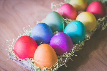 Vibrant colorful easter eggs on a wooden table