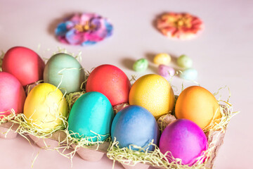 Fototapeta na wymiar Top Angle Colorful vibrant easter eggs on a light pink background
