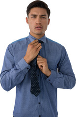 Portrait of young businessman adjusting necktie