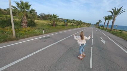 Fpv drone view of skater woman skateboarding on street - Powered by Adobe