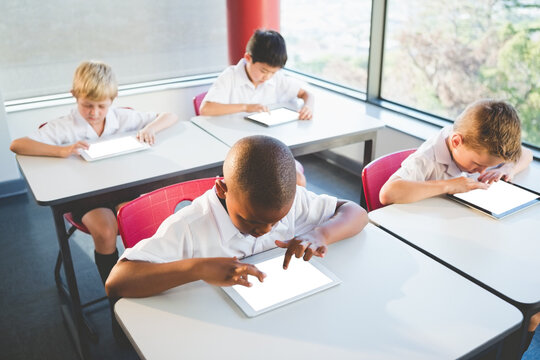 Children using digital tablet at classroom