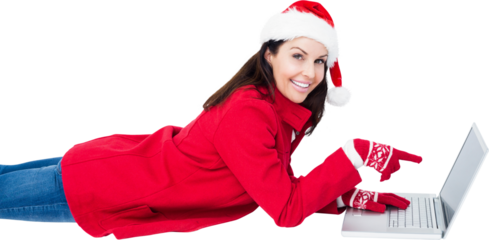 Brunette with santa hat lying on floor pointing laptop