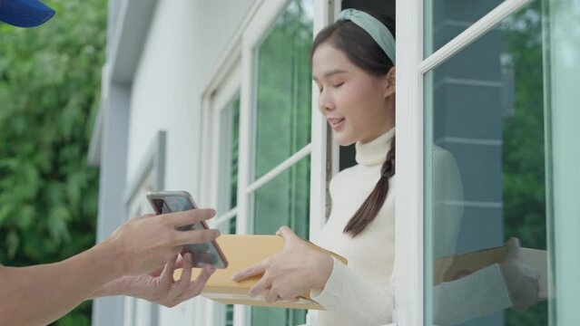 Happy smile Asian woman scan QR code for pay of food. Delivery man send deliver express. online shop, paper container, takeaway, postman, delivery service, packages, electronic money, Digital transfer