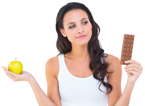 Pretty brunette deciding between apple and chocolate