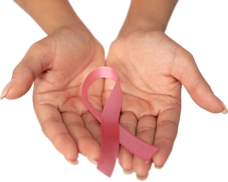 Two hands displaying pink ribbon for breast cancer awareness against white background
